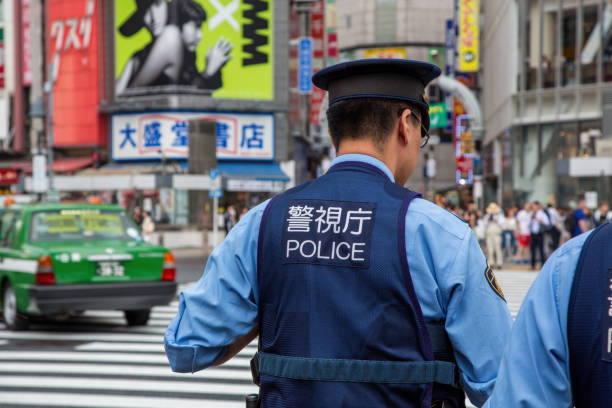 Japanese police presence at Shibuya Crossing, known as the scramble, the busiest pedestrian crossing in the world. Tokyo, Japan - 21 June 2023: Japanese police presence at Shibuya Crossing, known as the scramble, the busiest pedestrian crossing in the world. tokyo crowds on the famous shibuya crossing japan stock pictures, royalty-free photos & images