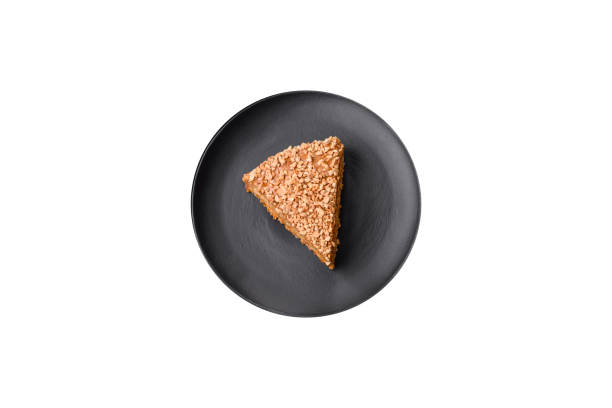 istock Delicious sweet puff waffle cake with cream and nuts cut into pieces 1657018639