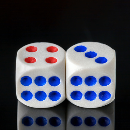 two white dice for playing dice on a dark background