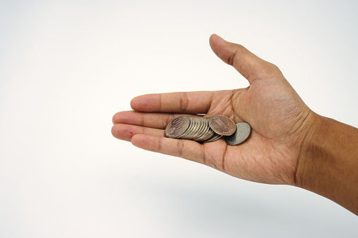 Small change income. Hand holding and receiving coin money on white background