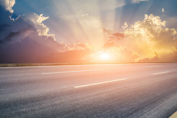 istock Empty asphalt road and clouds background at sunrise 1657057518