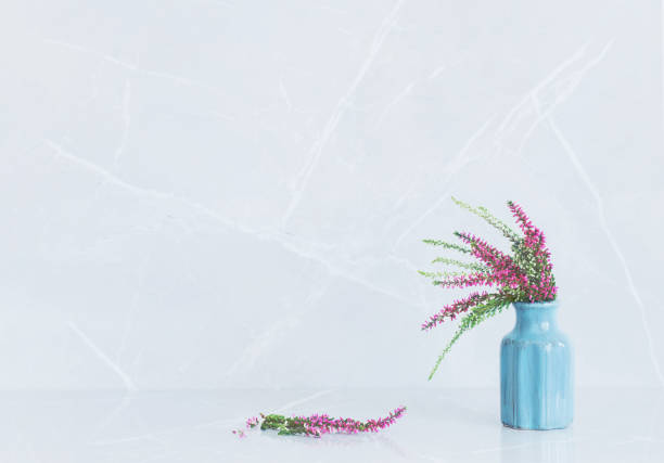 heather   bouquet in blue vase on gray marble background