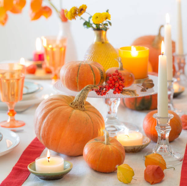 istock autumn table setting with burning candles and pumpkins 1657100811