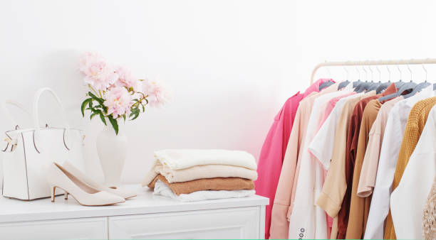 istock female clothes on hangers  in  white room 1657100878