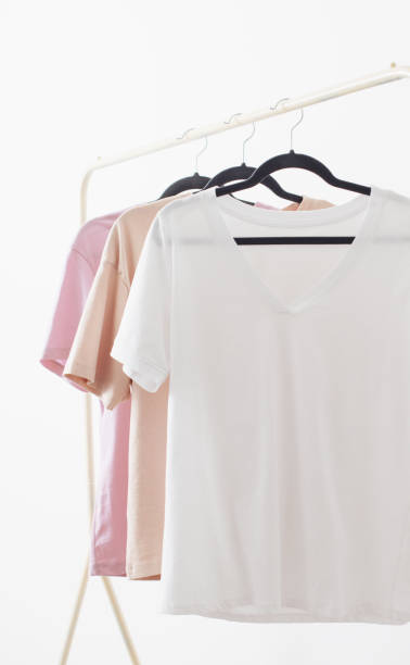 istock women's t-shirts on  hanger on  white background 1657100887