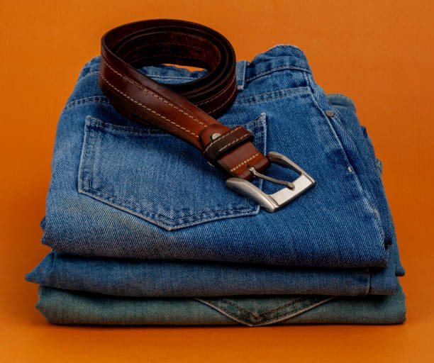istock folded jeans and brown belt on brown background.
shopping concept 1657137990