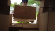 istock Delivery man take a package box in to transport van and checking inventory to prepare delivery to customer. 1657139623