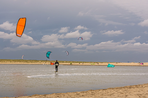 Kijkduin, The Netherlands - June 19, 2022: Kitesurfers at the Zandmotor on the beach of Kijkduin
