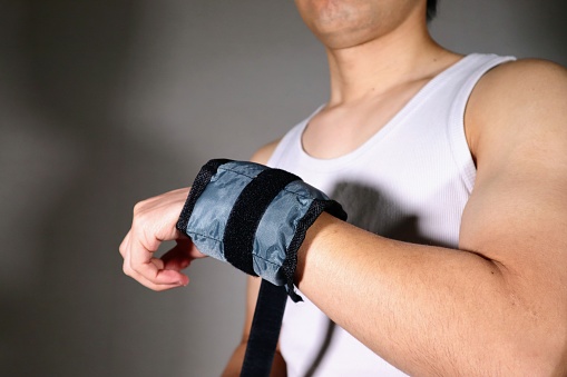 Photo of a person with weights on their arms