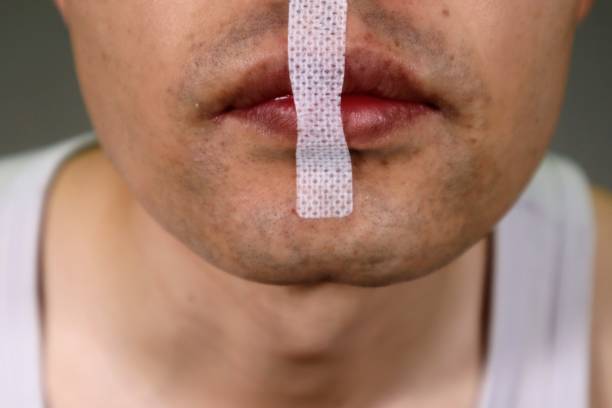 istock Person with mouth tape on mouth 1657154443