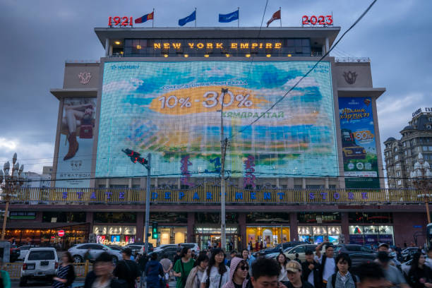 Ulaanbaatar, Mongolia - July 21, 2023: Pedestrians in front of the State Department Store at dusk.
