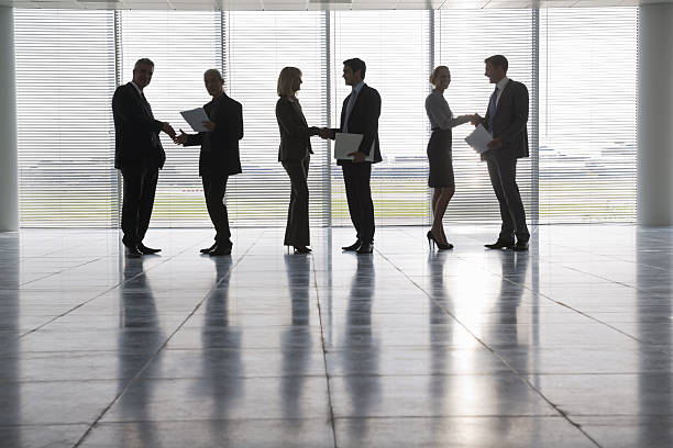 istock Business People Shaking Hands Against Window Blinds 165716990