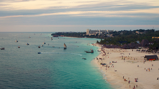 Zanzibar beach where tourists and locals mix together of colors and joy, concept of summer vacation, drone view of Kendwa beach, Tanzania