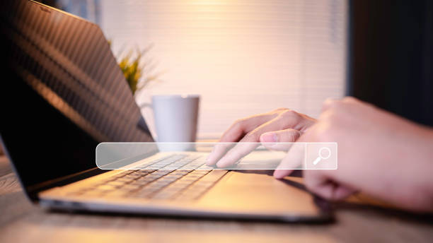 istock Searching Browsing Internet Data Information with blank search bar. hand of businessman working with computer laptop on desk in office Search Engine Optimization SEO Networking Concept. 1657200529