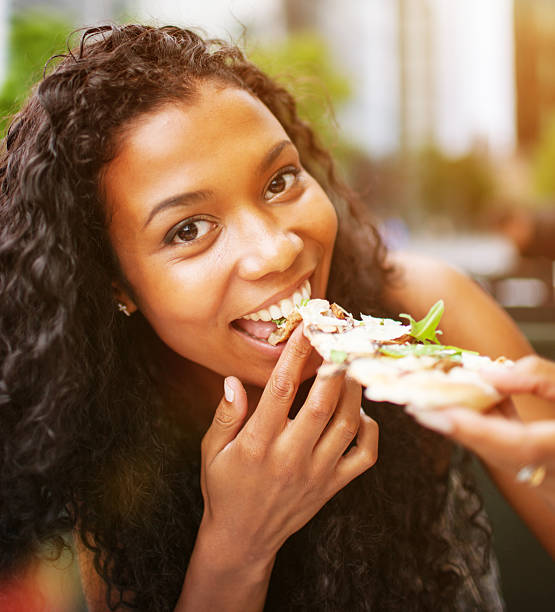 istock Happy Young Woman Eating Pizza 165720771