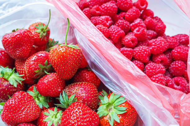 istock Strawberries and raspberries in plastic packaging. 1657212327