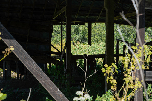 Storage shed at the side of a large warehouse.