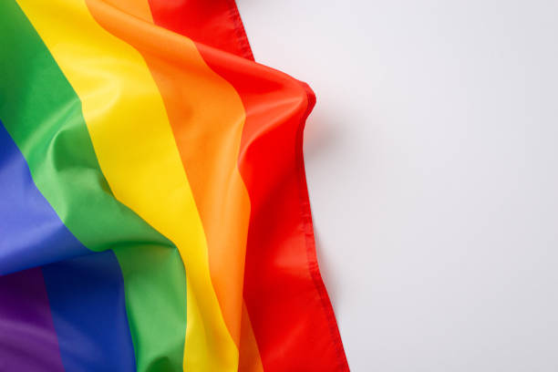 istock Embracing diversity and history: This top view image features a rainbow flag on a white backdrop, blank space ready to carry words of encouragement and remembrance for LGBT history month 1657231712