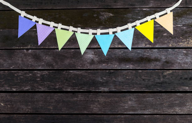 istock Colorful fabric bunting flag on old wood background 1657244807