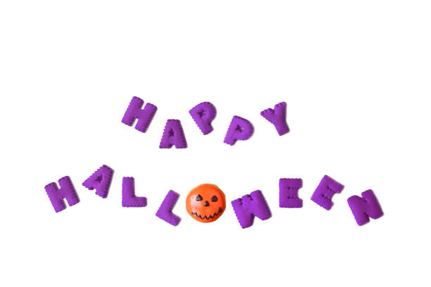 istock HAPPY HALLOWEEN typography made with alphabet cookies and Jack O Lantern doughnut on White Background 1657245390