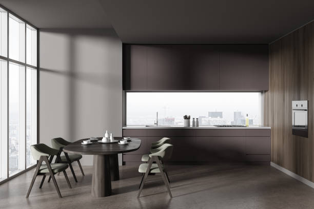 istock Minimalist kitchen interior with dining table and seats, cooking zone and window 1657246460