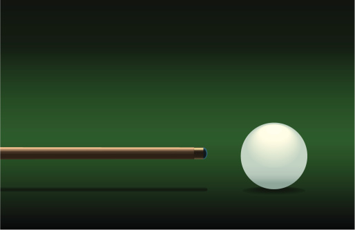 Side view of snooker cue and cueball on green background