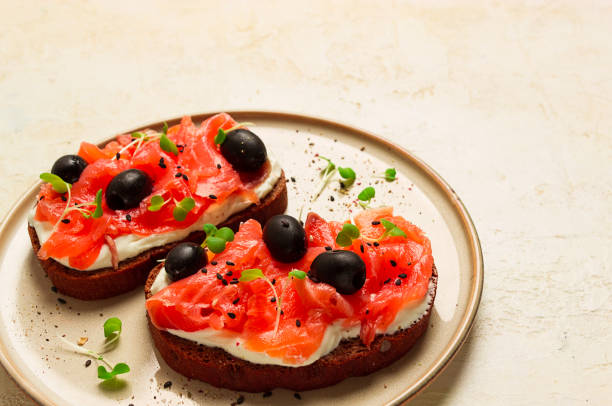 istock sandwiches with red fish, cream cheese, olives and microgreens, breakfast, 1657279205