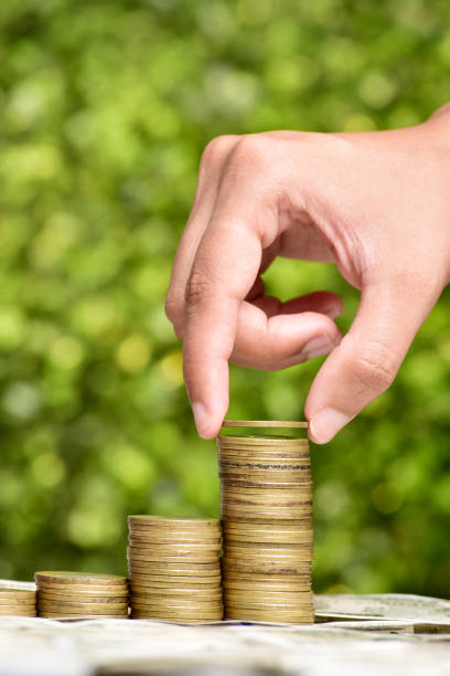 istock Closeup of hand put coin in coin stack 1657281414