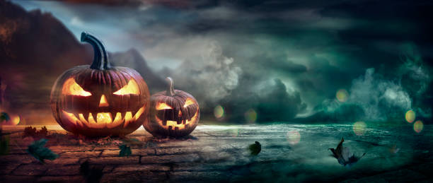 Halloween Pumpkins In A Spooky Night On Road With Mist stock photo