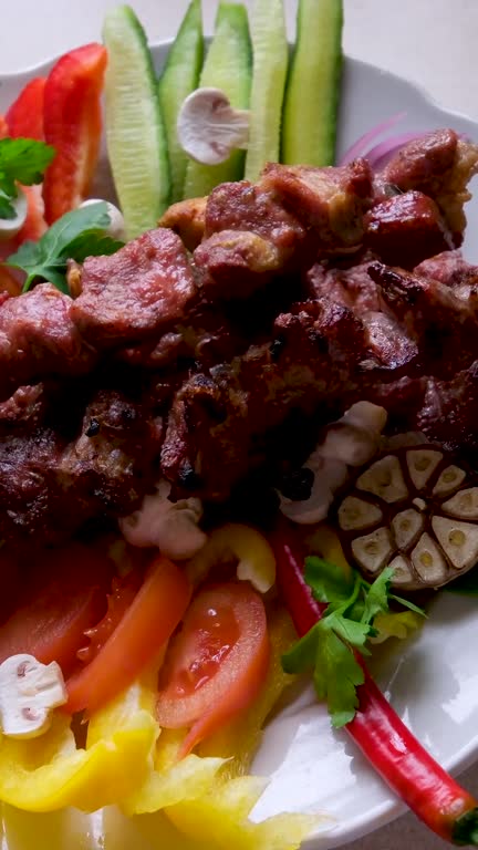 Traditional Russian shashlik on a barbecue skewer with paprika as closeup on an old board