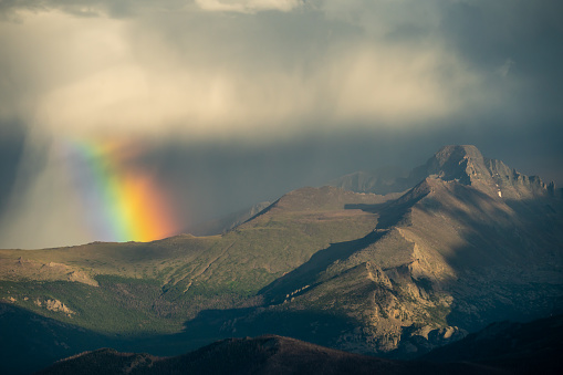 Wide Rainbow Falls from Storm Cloud over Mountains in Rocky Mountain National Park from Trail Ridge Road