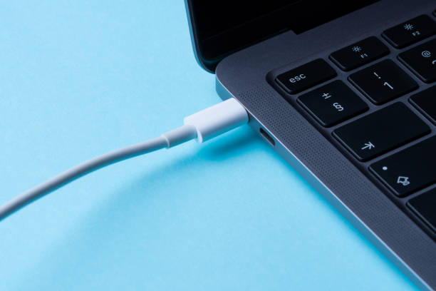 istock Laptop power. Cable with modern connector for charging and syncing your laptop with gadgets. Close-up. 1657362176