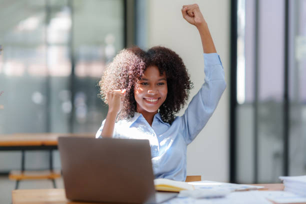 istock Businesswoman raising her hand in congratulation with document and laptop computer 1657383237