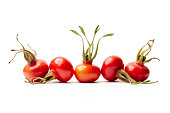 Fresh rose hips from Rosa Rugosa on white background