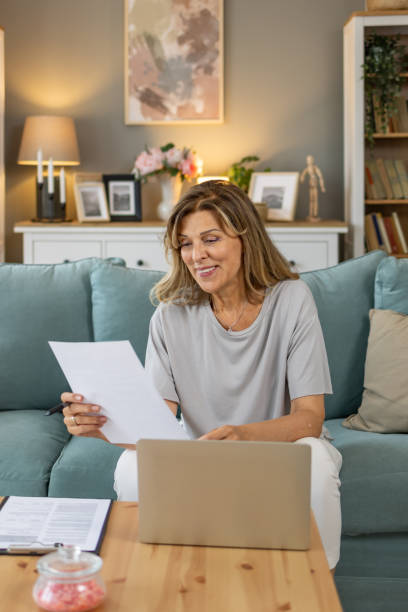 istock Senior woman doing paperwork at home 1657386418