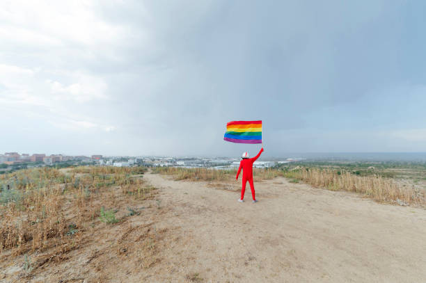 istock Astronaut with LGBT flag. View from behind 1657401613