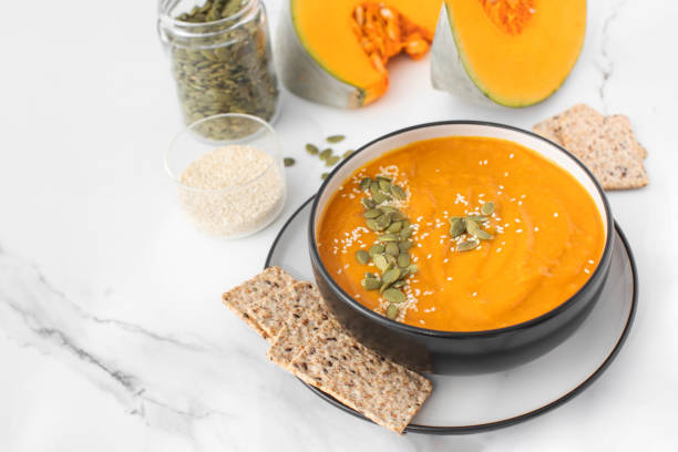 istock A bowl of pumpkin soup with mashed potatoes and seeds. Autumn menu. Copy space 1657410904