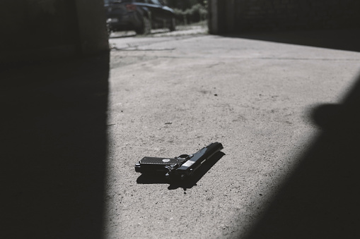 Gun lying on floor at crime scene
