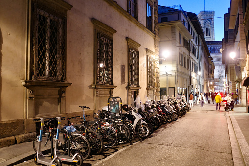 Florence, Italy - 22 Nov, 2022: Italian Vespa scooters lined up in a street in Florence