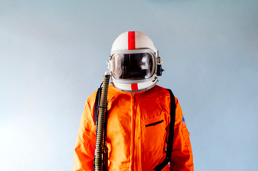 Unrecognizable man in orange astronaut suit