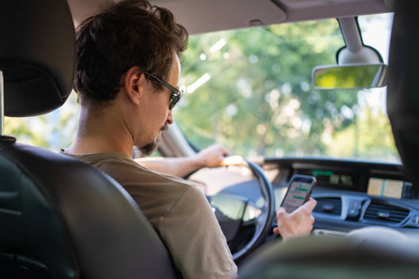 istock Caucasian man texting on a smart phone while driving a car 1657434205