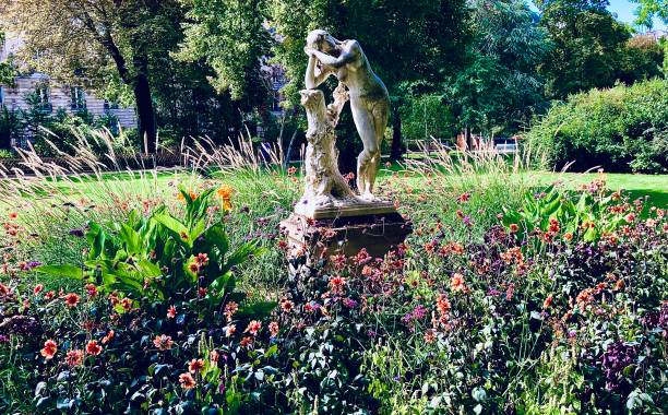 istock Statue in a Flower Garden in Paris 1657443795