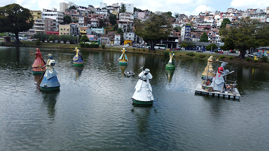 salvador, bahia, brazil - august 2, 2022: view of the lake from Dique de Itororo and sculpture of orixas, Candomble entities.