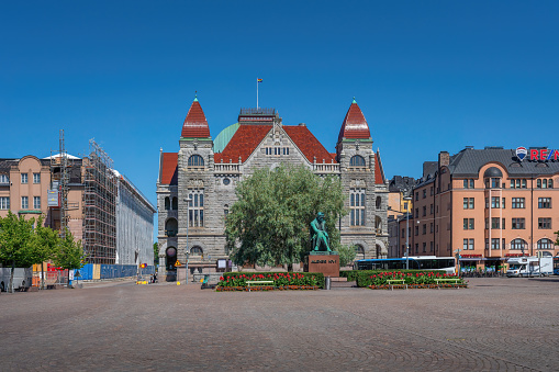 Helsinki, Finland - Jun 30, 2019: Railway Square with Finnish National Theatre and Aleksis Kivi Statue - Helsinki, Finland
