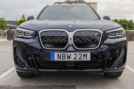 Sweden. Uppsala. 08.31.2023. Beautiful front view of 2023 BMW iX3 M Sport black car electric model.