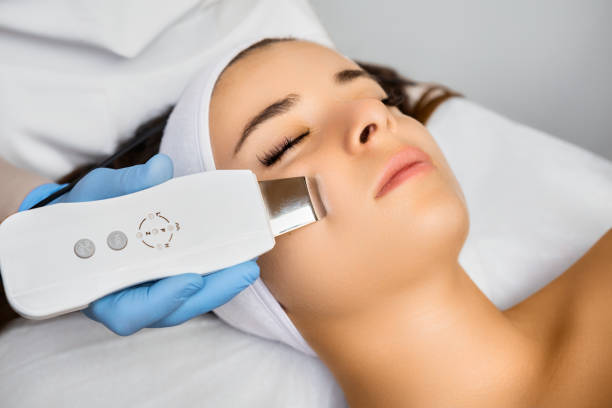 istock Expert cleans woman client face with ultrasonic equipment 1657523992