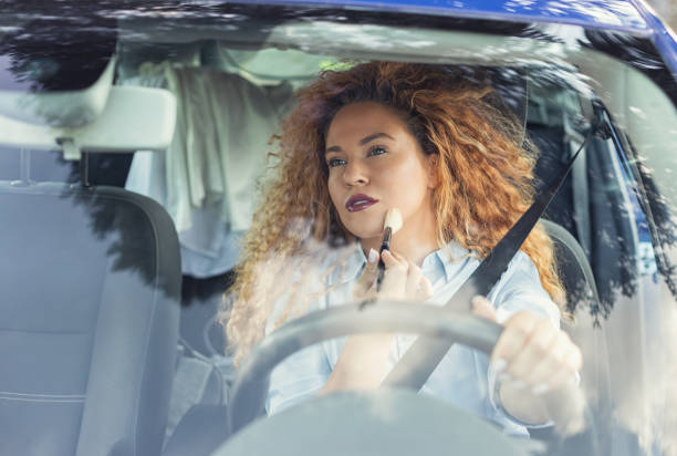 istock Beautiful woman being distracted whilst driving 1657548546
