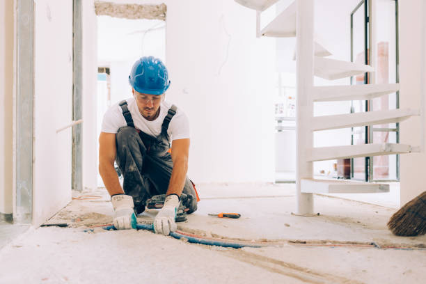 Caucasian Construction Worker Installing Pipes in an Apartment
