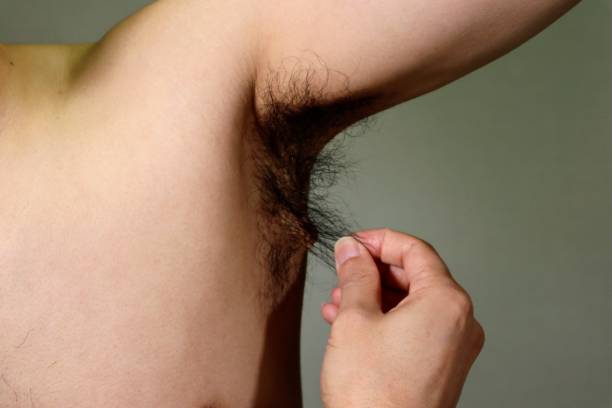 istock Naked man touching armpit hair 1657583072