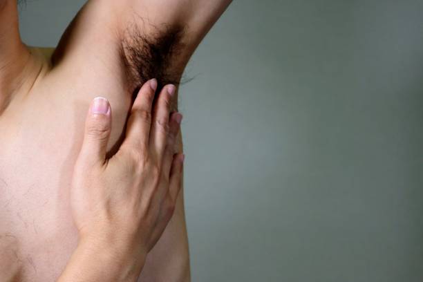 istock Naked man touching armpit hair 1657587901